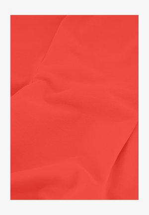 Close-up of smooth, bright red fabric with subtle folds and soft texture.