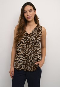 Haut sans manches avec imprimé léopard et décolleté en V, fabriqué en tissu léger. Offre une coupe décontractée et un ourlet arrondi.