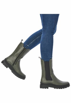 Green ankle boots with elastic side panels, a short zipper, and a rugged black sole. Smooth material with a matte finish.