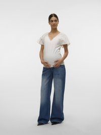 White V-neck top with short ruffled sleeves, paired with wide-leg blue denim jeans and black pointed-toe heels. Smooth fabric and casual style.