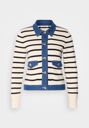 Striped cardigan featuring a cream base with black stripes, denim collar, and pockets. Front buttons and contrasting denim accents.