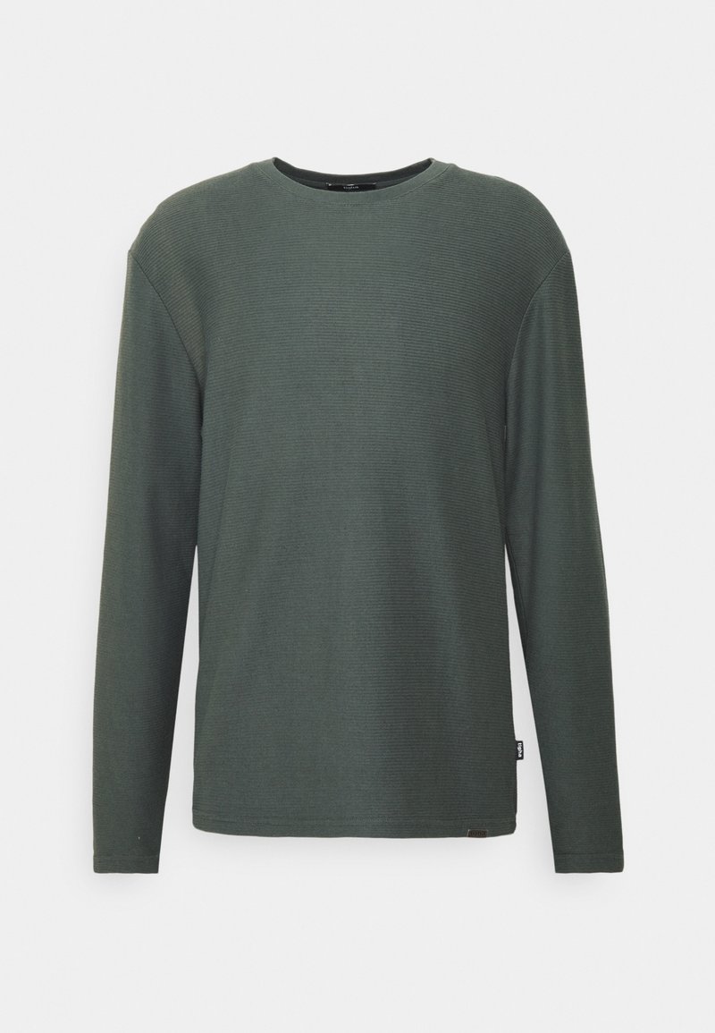 Koszulka z długim rękawem i prążkowanym, okrągłym dekoltem w ciemnozielonym kolorze. Miękka w dotyku, o luźnym kroju. Posiada małą metkę marki przy lamówce.