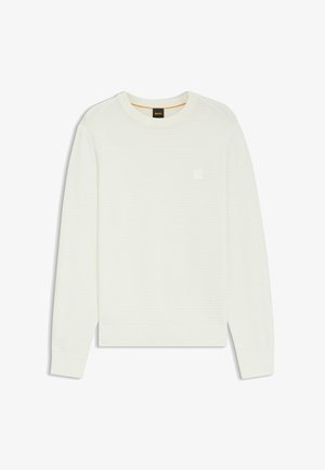 Ljus krämfärgad tröja med ribbad textur, rund hals och långa ärmar. Har en liten, diskret logotyp på bröstet. Mjuk, stickad tyg.
