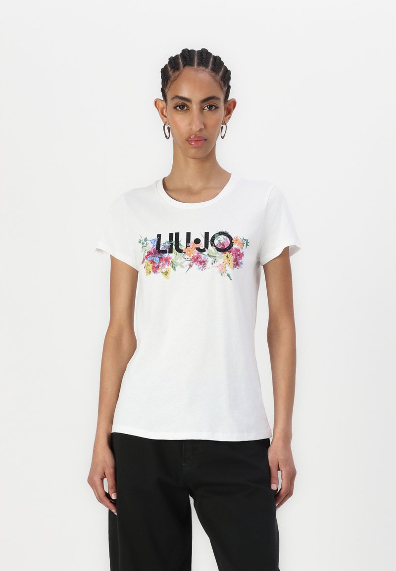 T-shirt en coton blanc avec un imprimé floral multicolore et le lettrage "LIU JO" sur la poitrine ; manches courtes, col rond.