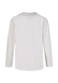 Langslavige shirt in effen wit, gemaakt van zachte stof. Heeft een ronde halslijn en een gladde textuur. Achteraan zichtbaar zonder patronen of versieringen.