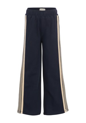 Donkerblauwe broek met wijde pijpen, beige en zwarte strepen aan de zijkanten en een elastische tailleband met het label Looxs Revolution.