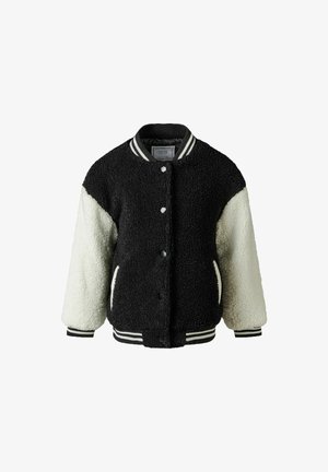 Veste colorée en noir et crème avec un tissu doux et texturé, fermeture à boutons sur le devant, poignets côtelés et accent coloré rayé au col.