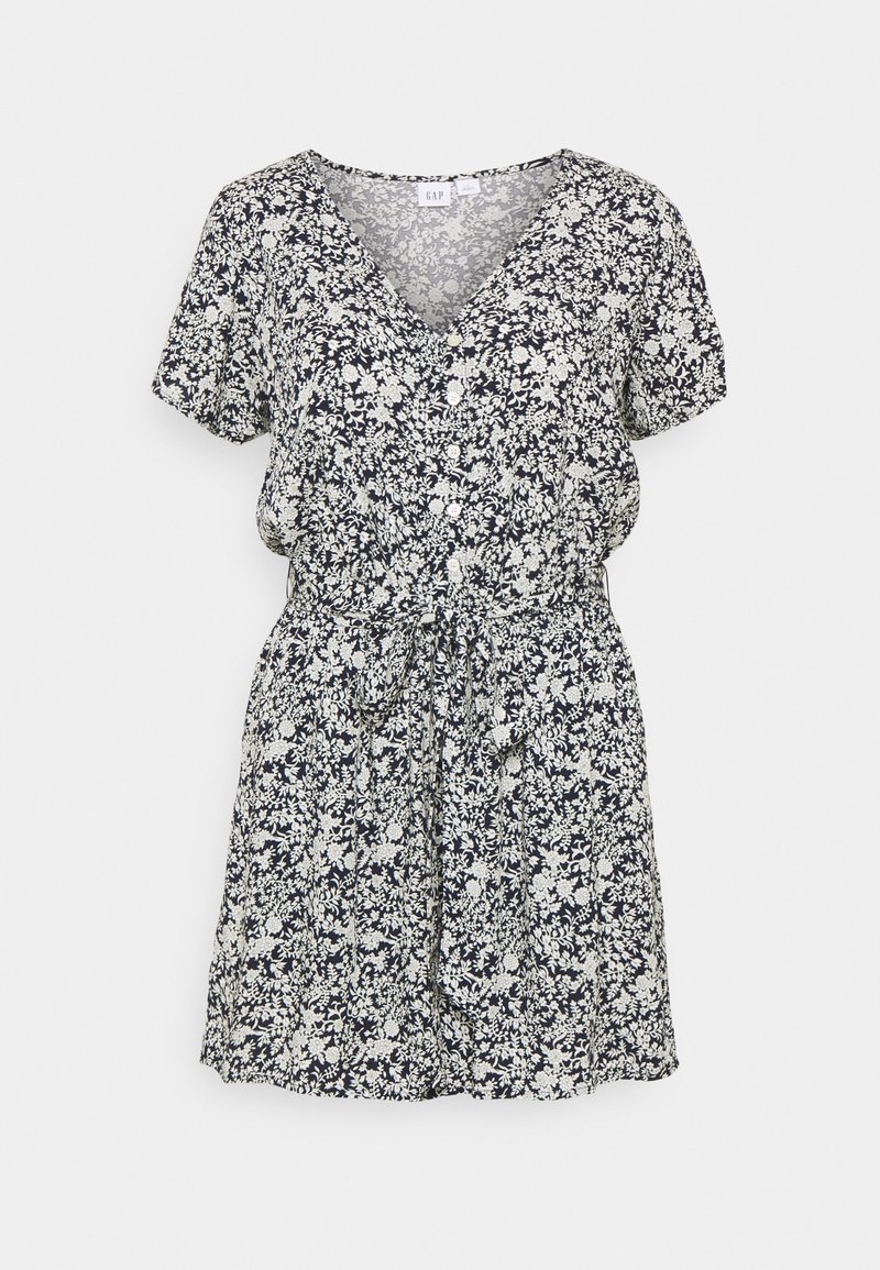 Robe courte à manches courtes à motifs floraux en noir et blanc, avec col en V, boutons à l'avant, et ceinture nouée à la taille, longueur au genou.