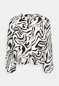 Veste à manches longues noire et blanche à motif abstrait avec col rond et poignets élastiques.