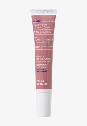 Tub av Korres Bright-Eyed Cushion Cream, rosa förpackning med vita accenter, text på flera språk, 15 mL storlek, slät matt finish.
