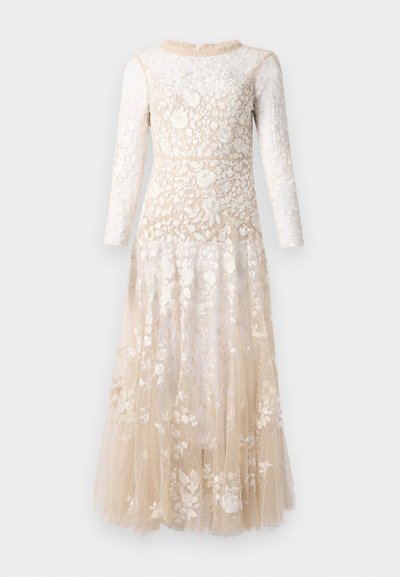 Robe nude longueur sol avec de longues manches transparentes, ornée de broderies florales blanches complexes.