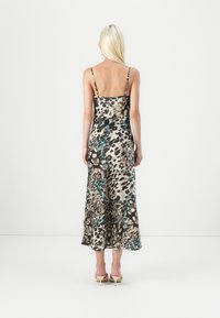 Sleeveless leopard print dress featuring a blend of brown, black, and teal hues, with thin straps and a flared hemline. Smooth fabric texture.