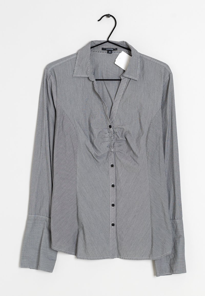 Chemise boutonnée à rayures noires et blanches, dotée d'un col, de manches longues et d'un détail froncé à l'avant.