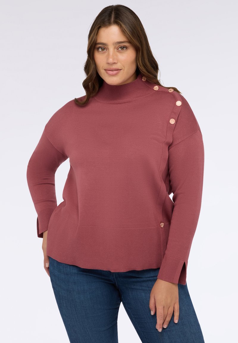 Staubrosafarbener Rollkragenpullover mit seitlichen Knopfdetails, gerippten Bündchen und einem lockeren Schnitt. Hergestellt aus weichem, glattem Stoff und verfügt über einen geraden Saum.