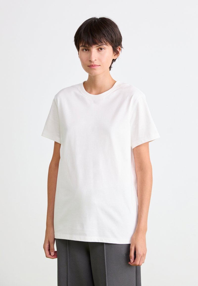 Hvid bomulds T-shirt med korte ærmer og rund halsudskæring, der har en afslappet pasform og glat tekstur.