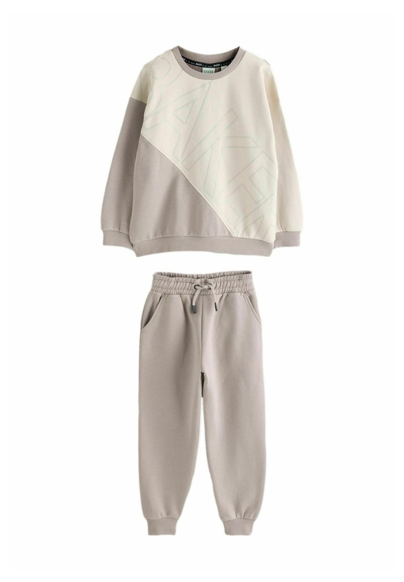 Light beige sweatshirt with a diagonal design and "BAKER" text, paired with matching elastic waist jogger pants in a similar tone.