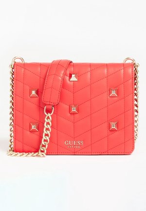Red quilted Guess handbag with gold chain strap, metal studs, and logo on front, displayed against a white background.