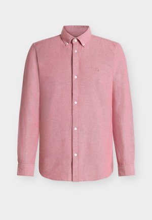 Košulja s kopčanjem na dugmad u svijetloružičastoj tkanini, s dugim rukavima. Ima ovratnik, prednja dugmad i mali izvezeni logotip na prsima.