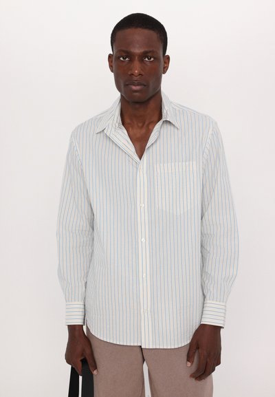 Long-sleeve button-up shirt in light blue and white stripes, featuring a front pocket, soft fabric, and a relaxed fit.