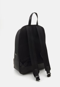 Black backpack made of smooth, durable material with mesh panels and padded shoulder straps. Adjustable straps and a top handle for carrying.