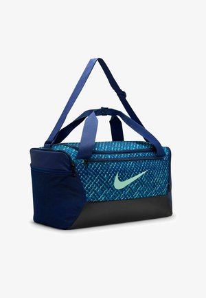 Duffle bag with dark blue fabric, turquoise patterned top, black base, dual handles, and adjustable shoulder strap. Features Nike logo.