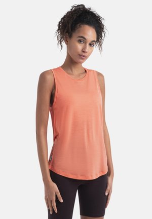 Sleeveless top in soft coral fabric with a round neck and curved hem. Paired with black shorts, features lightweight and breathable design.