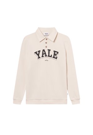 Polo shirt crème à manches longues avec un col, trois boutons marron et "YALE" en lettres noires en gras sur la poitrine. Tissu doux.