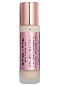 Fond de teint liquide dans un flacon givré avec un capuchon métallique rose. Étiquettes en texte noir incluant "Conceal & Define" et teinte "F1."