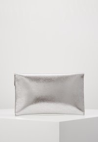 Pochette métallique argentée à texture lisse, de forme rectangulaire avec un léger éclat. Dispose d'une fermeture éclair et est dépourvue d'ornements.