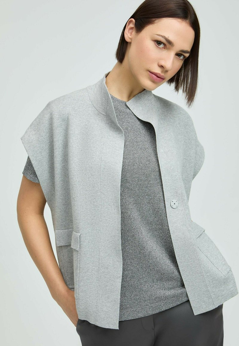 Light gray sleeveless cardigan with a round neckline, two front pockets, and a single button closure. Soft texture, minimalist design.