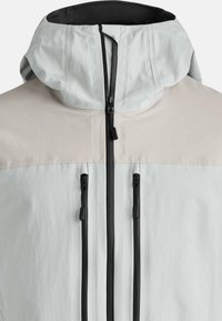 Light gray jacket with a beige upper section, adjustable hood, and two front zip pockets. Smooth texture with durable zippers.