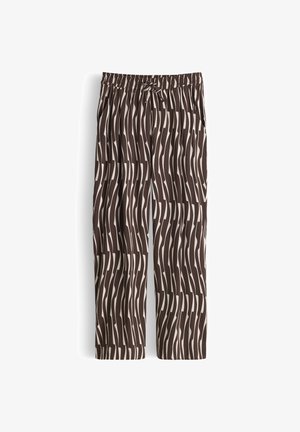 Pantalon ample avec taille élastique et lien, présentant un motif à rayures verticales ondulées marron et blanc.