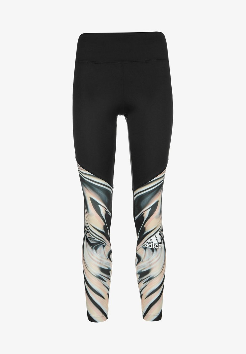 Leggings noirs avec une silhouette ajustée, présentant un motif marbré multicolore dans des teintes de beige, noir et blanc sur les côtés inférieurs.