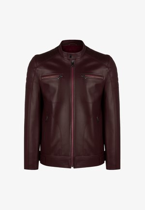 Chaqueta de piel burdeos con cuello alzado, detalles acolchados en los hombros y dos bolsillos en el pecho con cremallera. Textura suave y diseño ajustado.