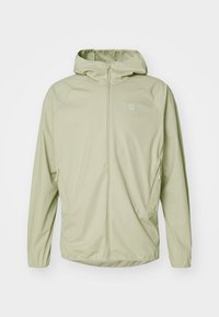 Veste zippée vert clair avec capuche, en matériau lisse, dotée de deux poches latérales et d'un petit logo sur la poitrine.