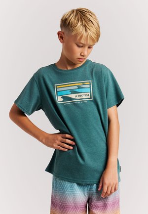 Türkisfarbenes Baumwoll-T-Shirt mit kurzen Ärmeln, das auf der Vorderseite eine mehrfarbige Wellen-Grafik und das Markenlogo zeigt, kombiniert mit gemusterten Shorts.