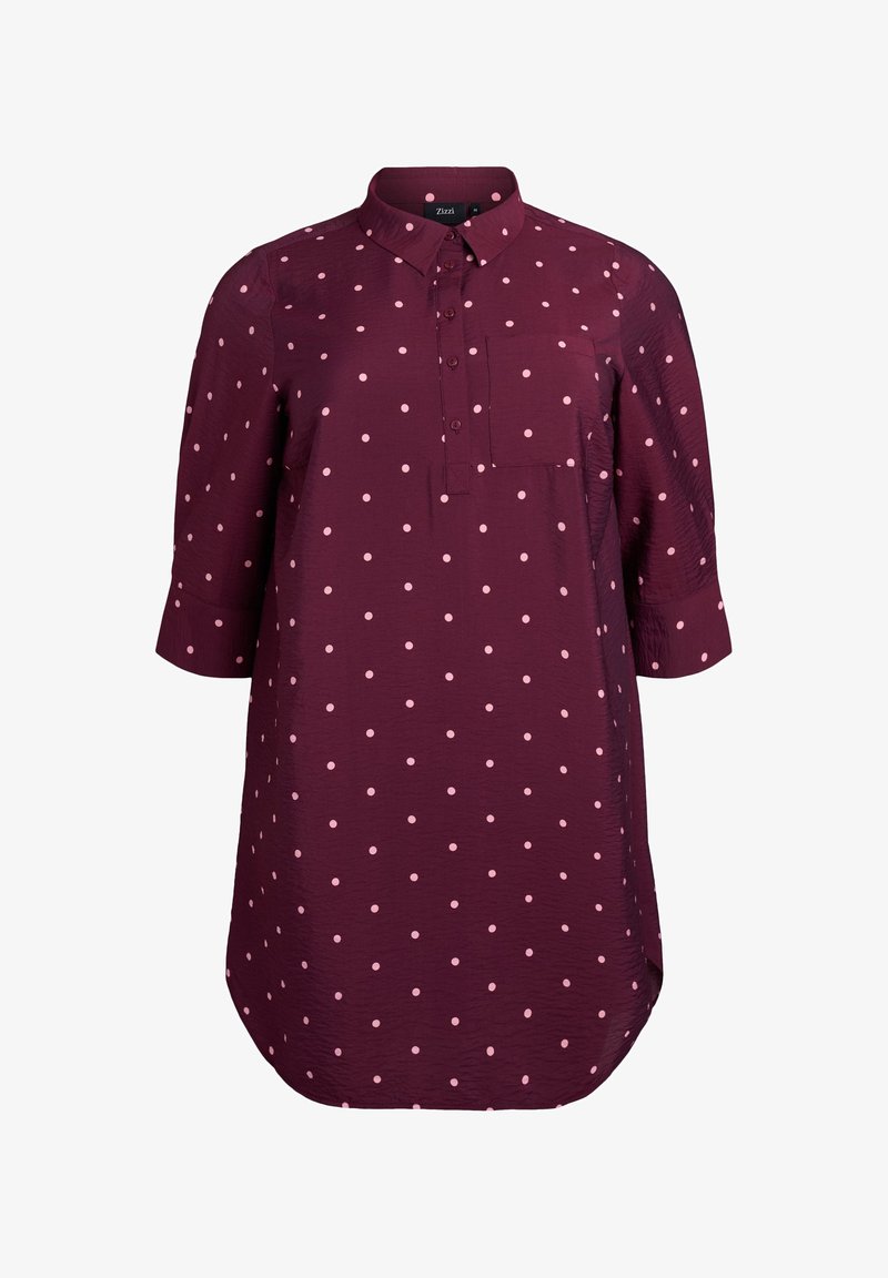 Bordowa koszula w białe kropki, zapinana na guziki z przodu, z kołnierzykiem, długimi rękawami i kieszenią na piersi. Doł k oszuli ma półokrągły brzeg. Wykonana z lekkiego materiału.