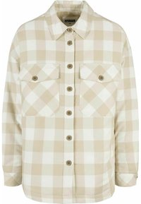 Camicia a maniche lunghe a quadri beige e bianca. Realizzata in tessuto con una texture morbida, presenta due tasche sul petto e bottoni marroni.