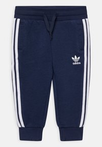 Pantaloni de trening bleumarin cu dungi laterale albe, realizați dintr-un material moale. Acestia dispun de un elastic la talie cu șnur și două buzunare laterale.