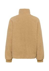 Bež villane jakki kõrge kaelusega, tekstuurse välispinnaga ja elastsete varrukaotstega. Omab lõdva lõiget ja ümmargust äärt mugavuseks.