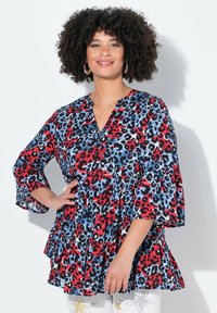Tunic con stampa leopardata rossa e blu, con scollatura a V, maniche a tre quarti a campana e orlo a strati, realizzata in tessuto leggero.