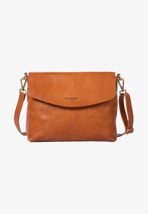 Tan leather shoulder bag with a flap closure, adjustable strap, and brass hardware. Features a smooth texture and embossed logo detail.