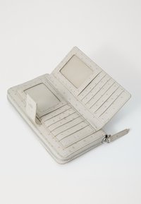 Light beige leather wallet with a zip closure. Interior features two card slots, a photo pocket, and multiple card holders with dotted texture.