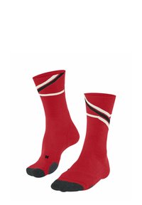 Calze rosse con strisce diagonali nere e bianche, con punta rinforzata nera. Texture a coste sul bordo.