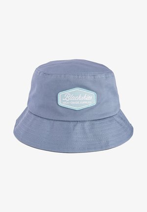 Light blue cotton bucket hat with a folded brim and a rectangular patch on the front featuring white text and a decorative border.