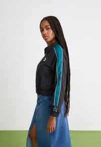 Puma T7  PLAY.LOUD. TRACK WV - Chaqueta de entrenamiento - black