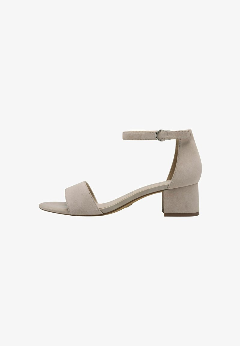 Beige suede block-heeled sandal with an ankle strap and a wide toe band, featuring a smooth texture and minimalistic design.