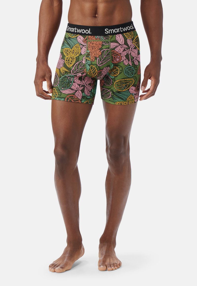 Boxer-kalsonger i grön tyg med ett färgglatt bladmönster i rosa, gult och orange. Har en svart midjeband med "Smartwool"-logotyp.