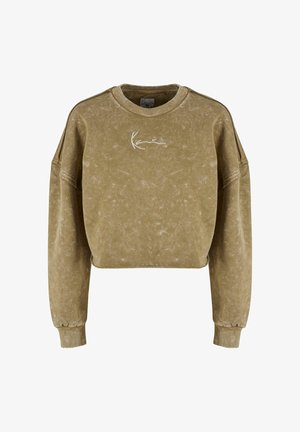 Olíva zöld, cropped pulóver, texturált felülettel, széles ujjaival és fehér logóval a mellkason. Bordás mandzsetta teszi teljessé a megjelenést.
