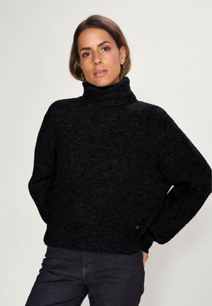 Black turtleneck sweater with a textured knit design and dropped shoulders. Features a relaxed fit and a small logo detail at the hem.